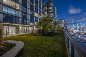 a grassy yard in front of a building at Opulent Harbourside Sanctuary in Melbourne
