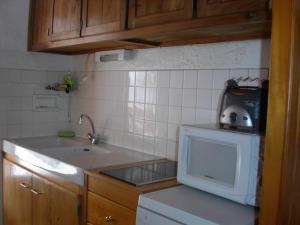 a small kitchen with a sink and a microwave at Gite Deux-Eaux in Saint-Martial