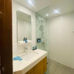 a bathroom with a sink and a glass shower at V Boutique Hotel Boracay in Boracay +13 photos