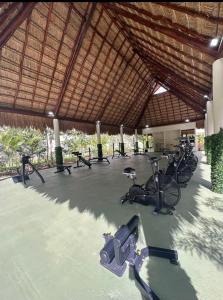 a gym with a bunch of bikes in a building at Nare bokova in Tulum