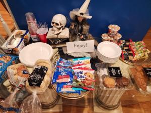 a table filled with food and a skeleton figurine at Old Salem House 15 mins from downtown Salem in Peabody