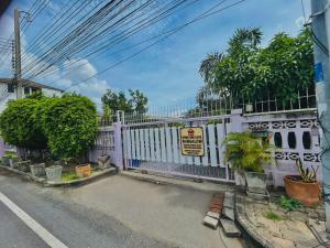a white fence on the side of a street at Home one love Ayutthaya bangalow zone in Phra Nakhon Si Ayutthaya