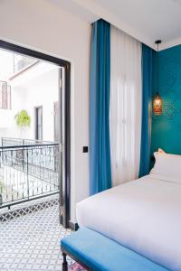 a bedroom with a bed and a balcony at Riad Looma in Marrakesh +64 photos