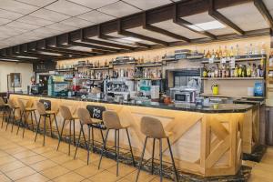 a bar with a row of stools in a restaurant at HOSTAL LAS PALOMAS in Lucena