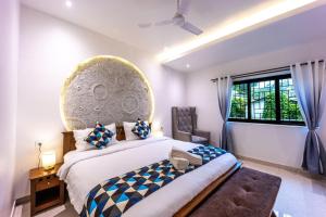 a bedroom with a large bed and a window at House Of Josma By There4You Tourism in Candolim +59 photos