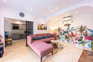 a living room with a couch and a table at House Of Josma By There4You Tourism in Candolim