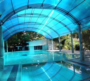 an indoor swimming pool with a blue ceiling at Tilko Jaffna City Hotel in Jaffna
