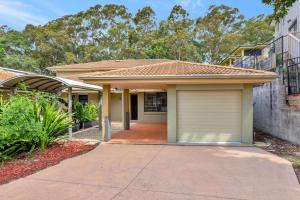 a house with a garage in front of it at Cleopatra's Oasis at Lagoon Estate in Nelson Bay