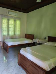 a bedroom with two beds and a window at Nice place in Marawila
