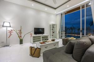 a living room with a couch and a tv at Villa Namo Chaweng 2 Bed Garden Pool in Koh Samui