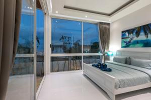 a bedroom with a bed and a large window at Villa Namo Chaweng 2 Bed Garden Pool in Koh Samui +31 photos