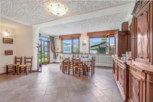 a kitchen and dining room with a table and chairs at Casa Malpensata - Happy Rentals in Porto Valtravaglia
