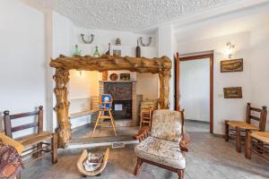 a living room with a chair and a fireplace at Casa Malpensata - Happy Rentals in Porto Valtravaglia