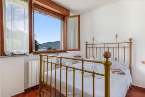 a bedroom with a bed and a large window at Casa Malpensata - Happy Rentals in Porto Valtravaglia +22 photos