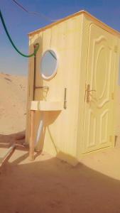 a bathroom with a sink and a door in the desert at مخيمات للايجار طريق الثمامه in Riyadh