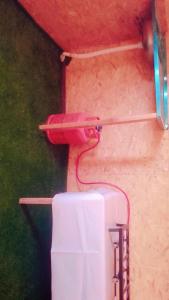 a pink toilet in the corner of a wall at مخيمات للايجار طريق الثمامه in Riyadh