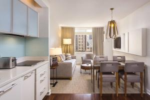 a kitchen and living room with a couch and a table at Club Wyndham Midtown 45 in New York