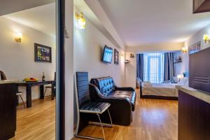 a living room with a couch and a bedroom at GVC New Gudauri Block-1 in Gudauri