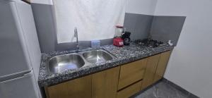 a kitchen counter with a sink and a stove at pent-house 3 planta alta in San José del Cabo