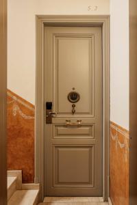 a door with a gold handle in a hallway at Barcelona Apartment Milà in Barcelona