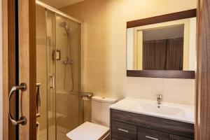 a bathroom with a toilet sink and a shower at Barcelona Apartment Milà in Barcelona +18 photos