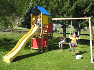a group of children playing on a playground at Älpi Retreat by Saas Grund in Saas-Grund