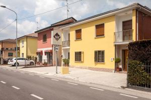 a yellow building on the side of a street at I Due Orfici in Cona