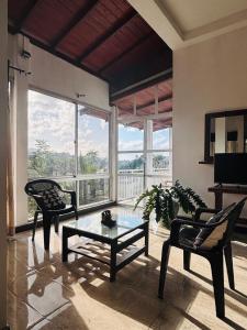 a living room with two chairs and a coffee table at Heavenly Horizon Villa in Kandy