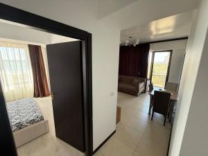 a room with a door leading to a room with a bedroom at Summerland Flat in Mamaia