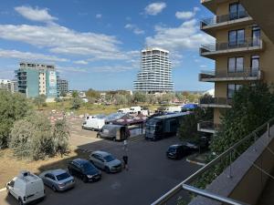 a parking lot with parked cars and a building at Summerland Flat in Mamaia +3 photos