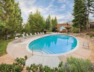 a swimming pool in a yard with chairs around it at WorldMark Lake Tahoe in Stateline