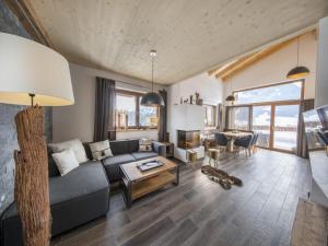 a living room with a couch and a table at Alpine Chalet with Mountain Views in Neukirchen am Großvenediger