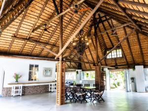 a room with a wooden ceiling with chairs and a table at Gillys Accommodation in Camperdown