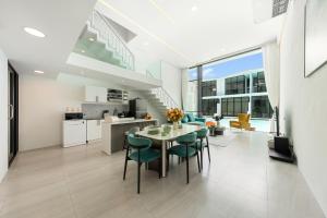 a kitchen and dining room with a table and chairs at Pool Access Spacious Townhouse and Kids Slide in Koh Samui