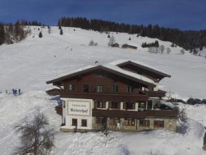 a building on a ski slope with snow on it at Large Apartment in Maria Alm with Terrace in Maria Alm am Steinernen Meer +23 photos