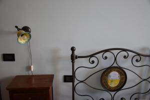 a metal bed with a lamp next to a table at La Casa Nell'Oliveto Bed & Breakfast in Acquasparta