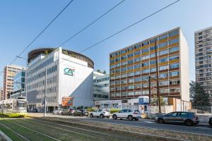 a city with cars parked in front of buildings at PAUL - Confortable studio - design et raffiné in Saint-Étienne