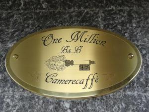 a gold plate with a one millionsteen commemorative sign at One M in Borgarello