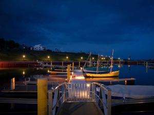 a dock with two boats in the water at night at Ferienwohnung Penthaus ILSE in Großräschen