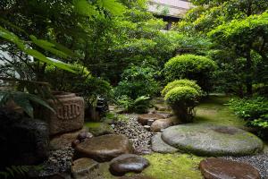 a garden with rocks and plants and trees at Loisir Hotel Classic Garden Kyoto Sanjo in Kyoto +57 photos