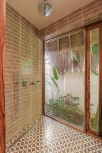 a bathroom with a shower with a glass door at Villa Veloso A Private Villa with Pool in Sta Fe Siargao in General Luna