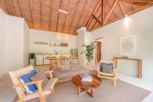 a living room with a couch and chairs and a table at Villa Veloso A Private Villa with Pool in Sta Fe Siargao in General Luna