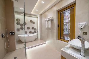 a bathroom with a sink and a glass shower at Kamil Palace in Khiva +87 photos