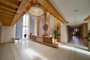 a large lobby with a large room with a table at Kamil Palace in Khiva