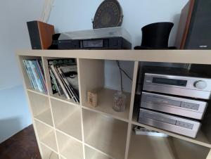 a book shelf with a dvd player and a printer at Au Bonheur des Voyageurs, 30' de Paris in Villennes-sur-Seine +15 photos
