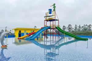 a playground in a pool of water with a slide at S Tilu Heroy Hill Resort Pangalengan Bandung RedPartner in Pengalengan