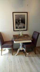 a table with two chairs and a candle on it at Stadtblick in Salzburg