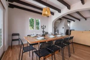 a dining room with a large wooden table and chairs at Villa Los Tres Almendros in Marbella