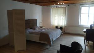 a bedroom with a bed and a large window at Stadtblick in Salzburg