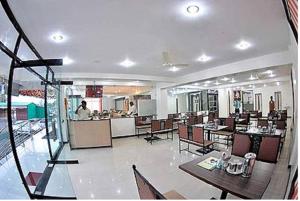 a dining room with tables and chairs and a restaurant at KDM Hotel Sai Geeta Shirdi a walk away from Saibaba Temple in Shirdi